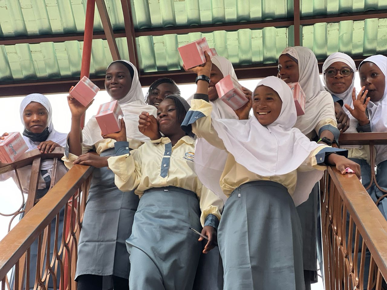 Students posing together with pad boxes